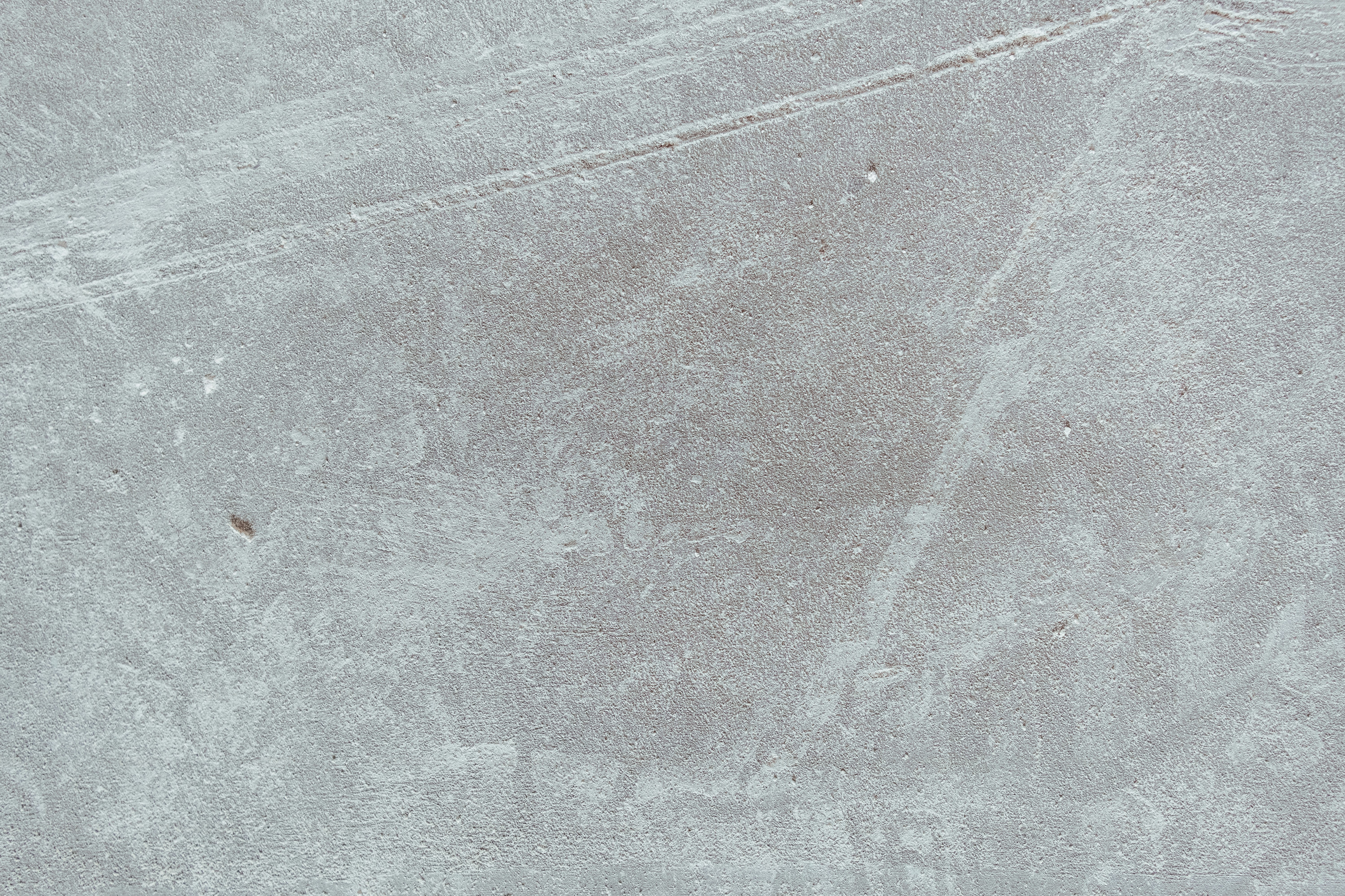 a person riding a skateboard on a concrete surface